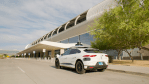 a waymo jaguar i-pace AV robotaxi approaching curb at phoenix 44th street sky train station