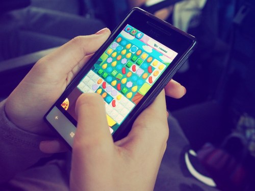person playing candy crush on mobile