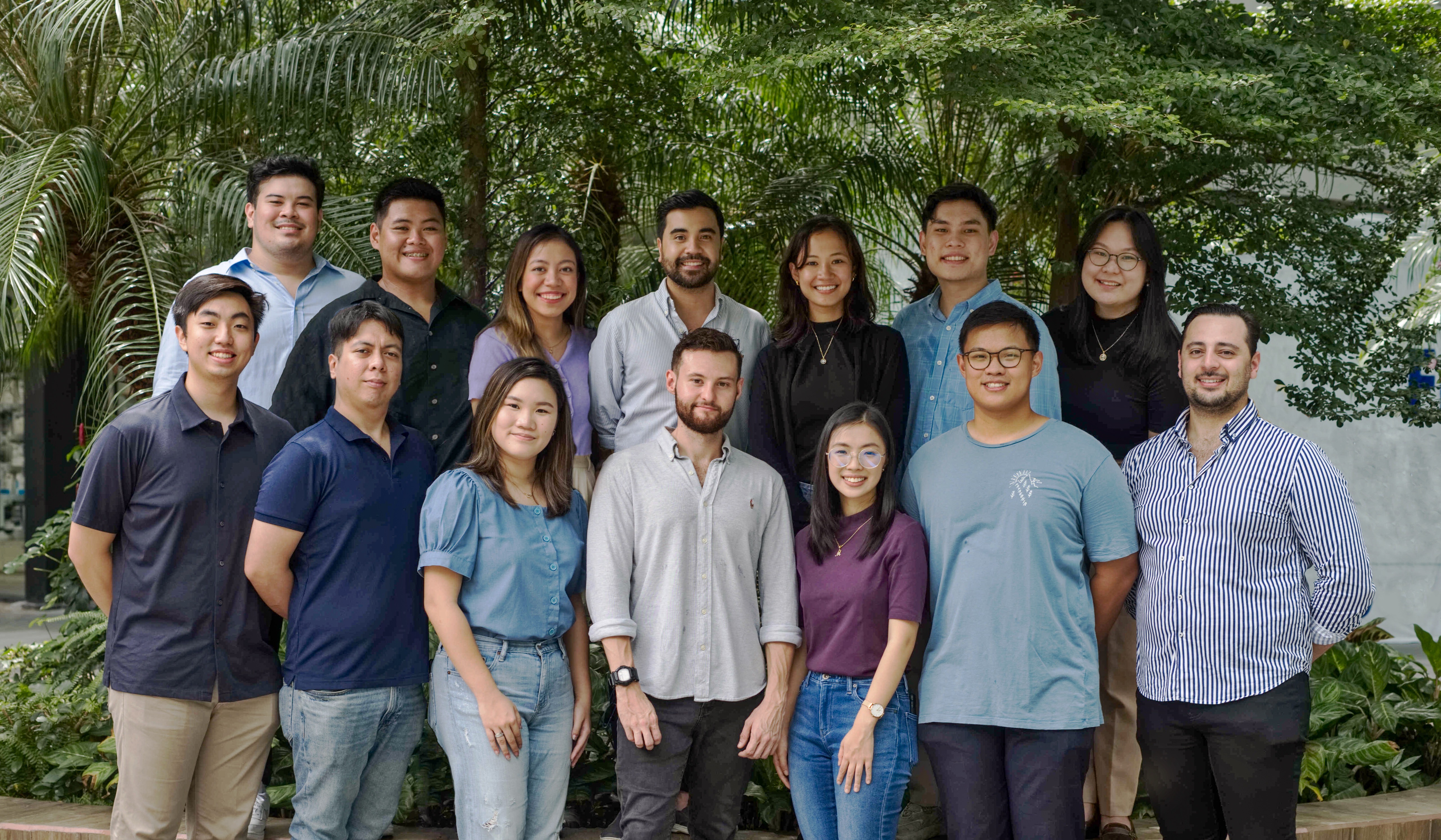 klikit's team posing outside in front of trees