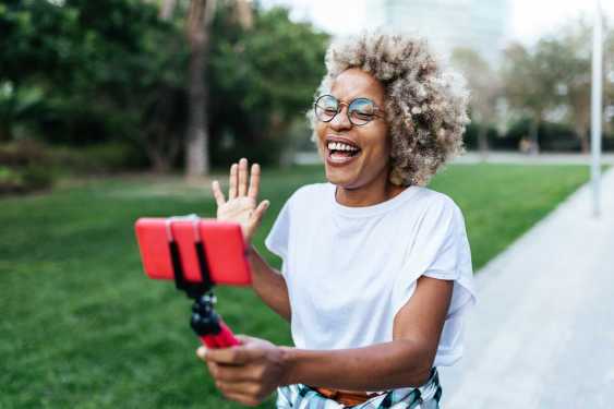a vlogger recording content in a park