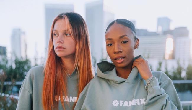 two women wearing Fanfix hoodies