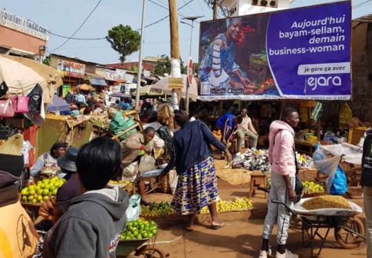 Ejara billboard overlooking an outdoor market