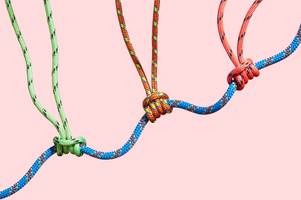 Three coloured ropes supporting a larger rope