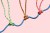 Three coloured ropes supporting a larger rope