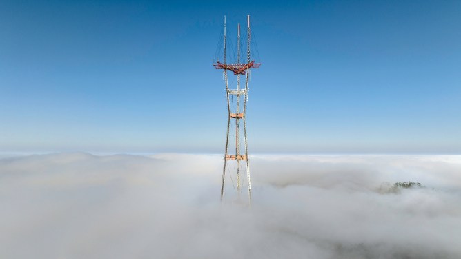 photos of a foggy Sutro Tower in San Francisco breaking through fog.