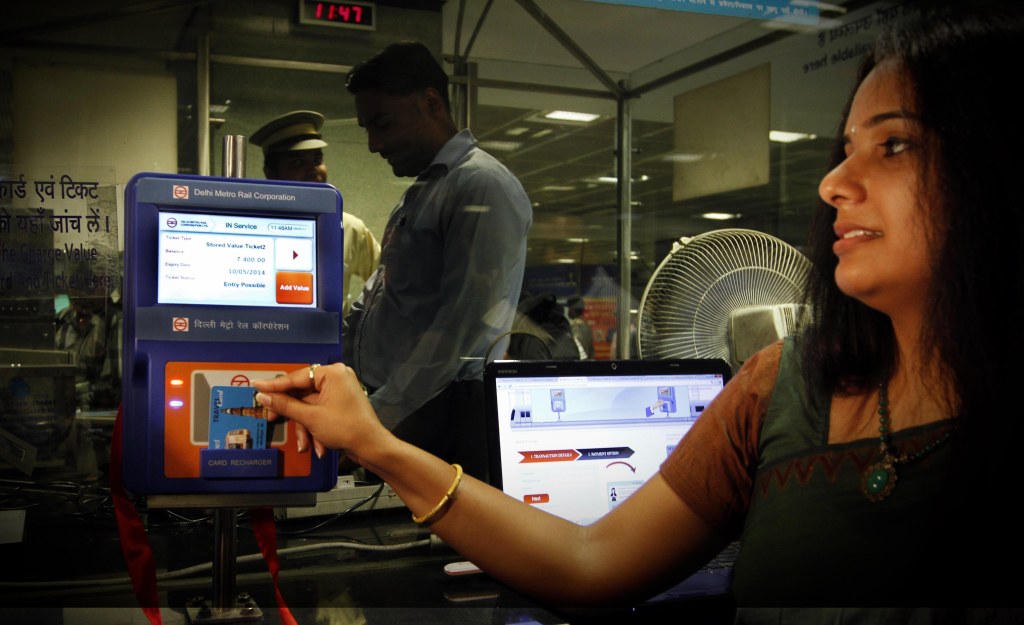 An Indian woman recharging her Delhi Metro smart card at a station in New Delhi.