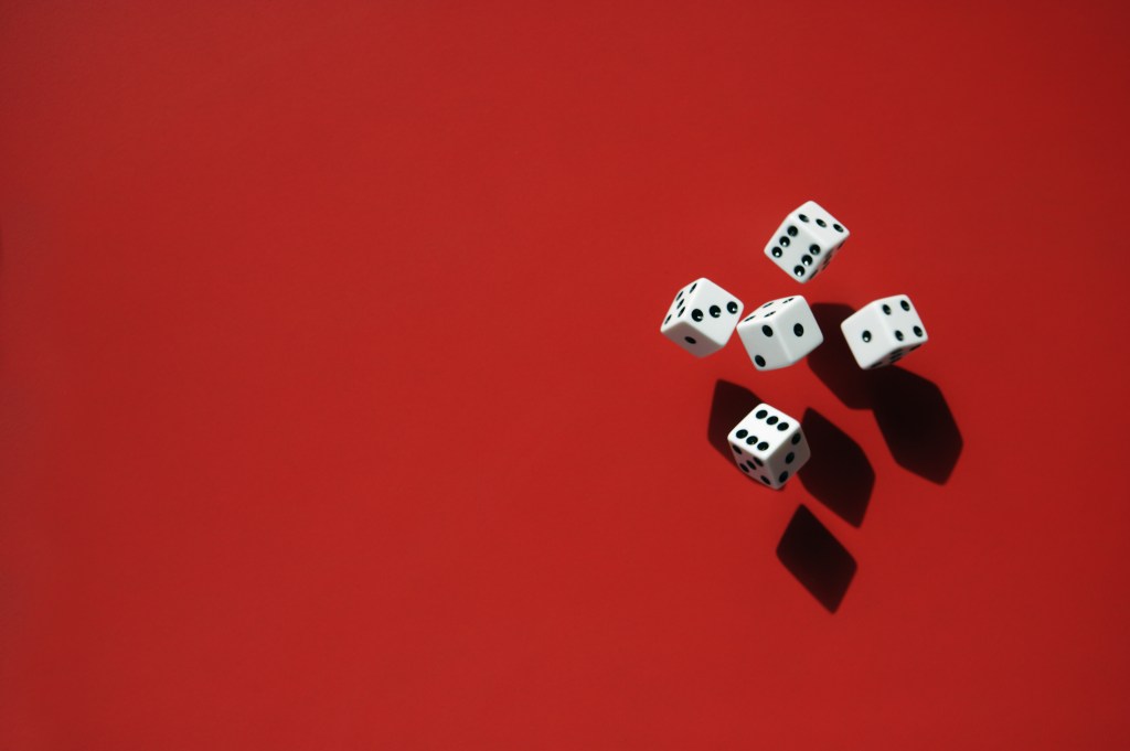 Image of five dice against a red background