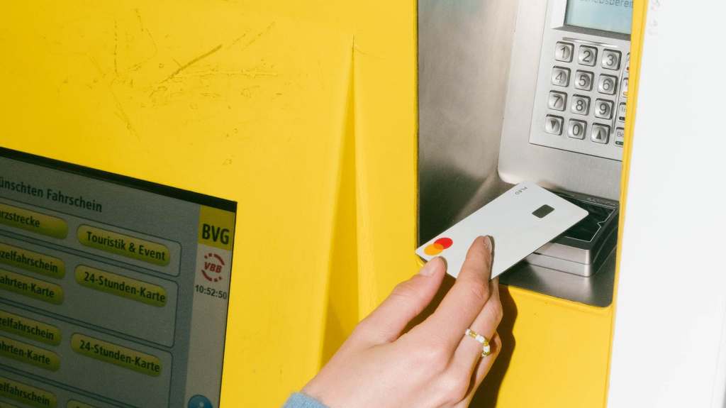 Person insering credit card into ATM machine
