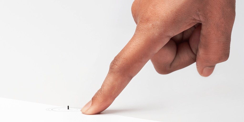 finger pointing at a tiny, remote-controlled medical robots