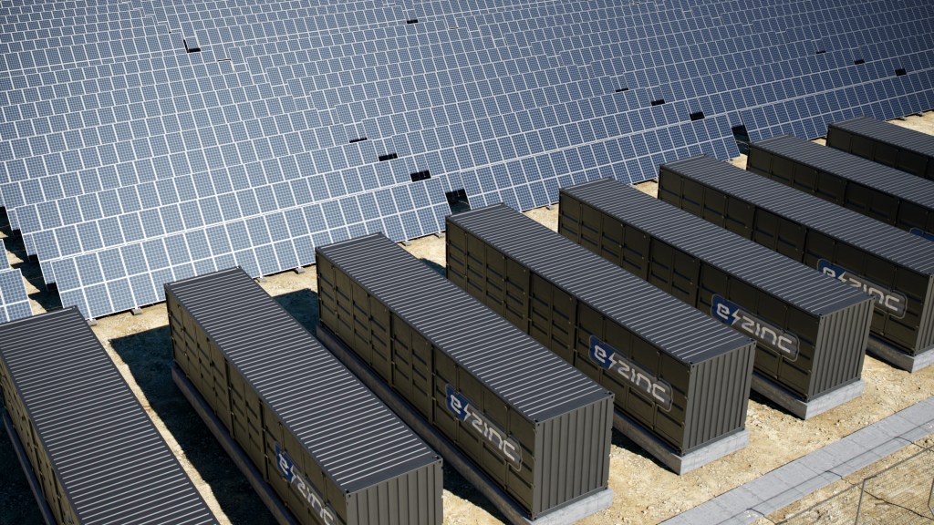 A render of numerous e-zinc battery units beside solar arrays