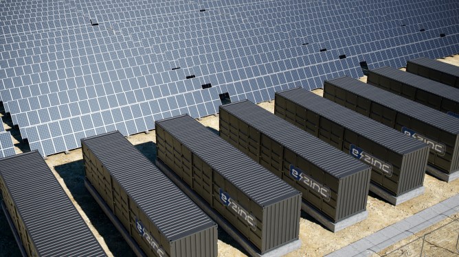 A render of numerous e-zinc battery units beside solar arrays