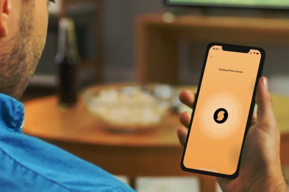 Man lokking at SoundHound app on smartphone