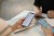 Three people, seated at table, holding cell phones.