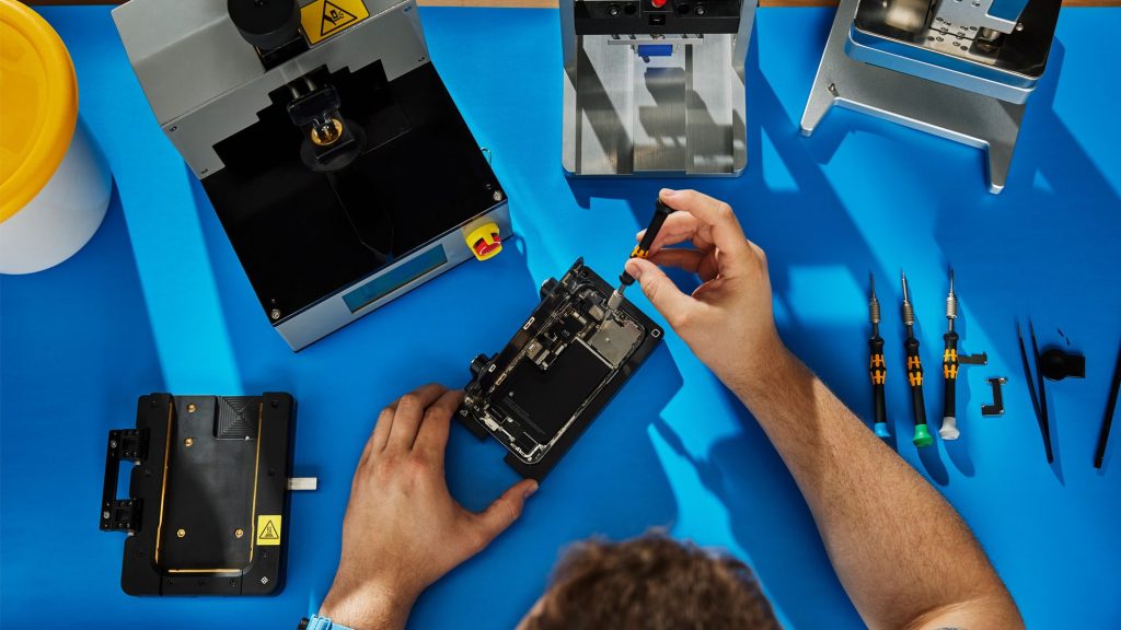 person doing self-repair on electronic devices