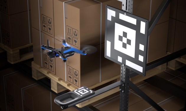 Autonomous warehouse drone hovering over docking station