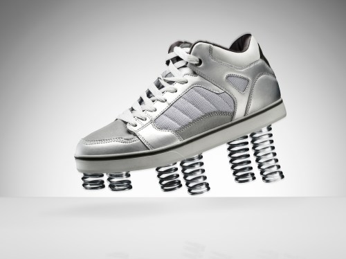 A sports shoe jumping in the air with springs on the bottom