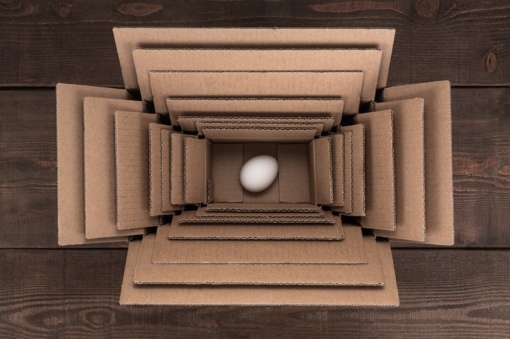 Egg Packed in Multi Layered Boxes on Wood Floor.