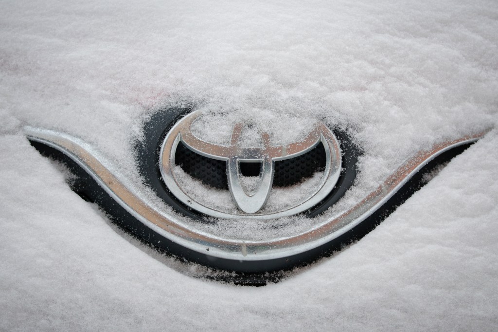 Toyota badge buried under snow.