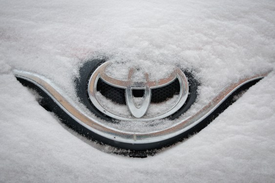 Toyota badge buried under snow.