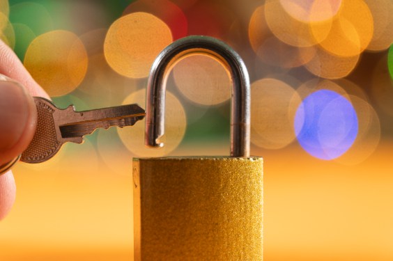 A hand holding a key next to a lock, used in post about Digip
