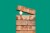 Egg between bricks on green background