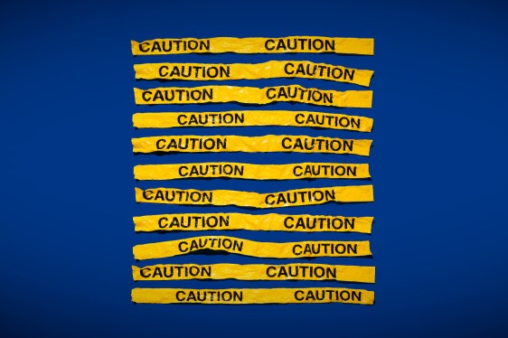 strips of yellow caution tape on a blue vignette background