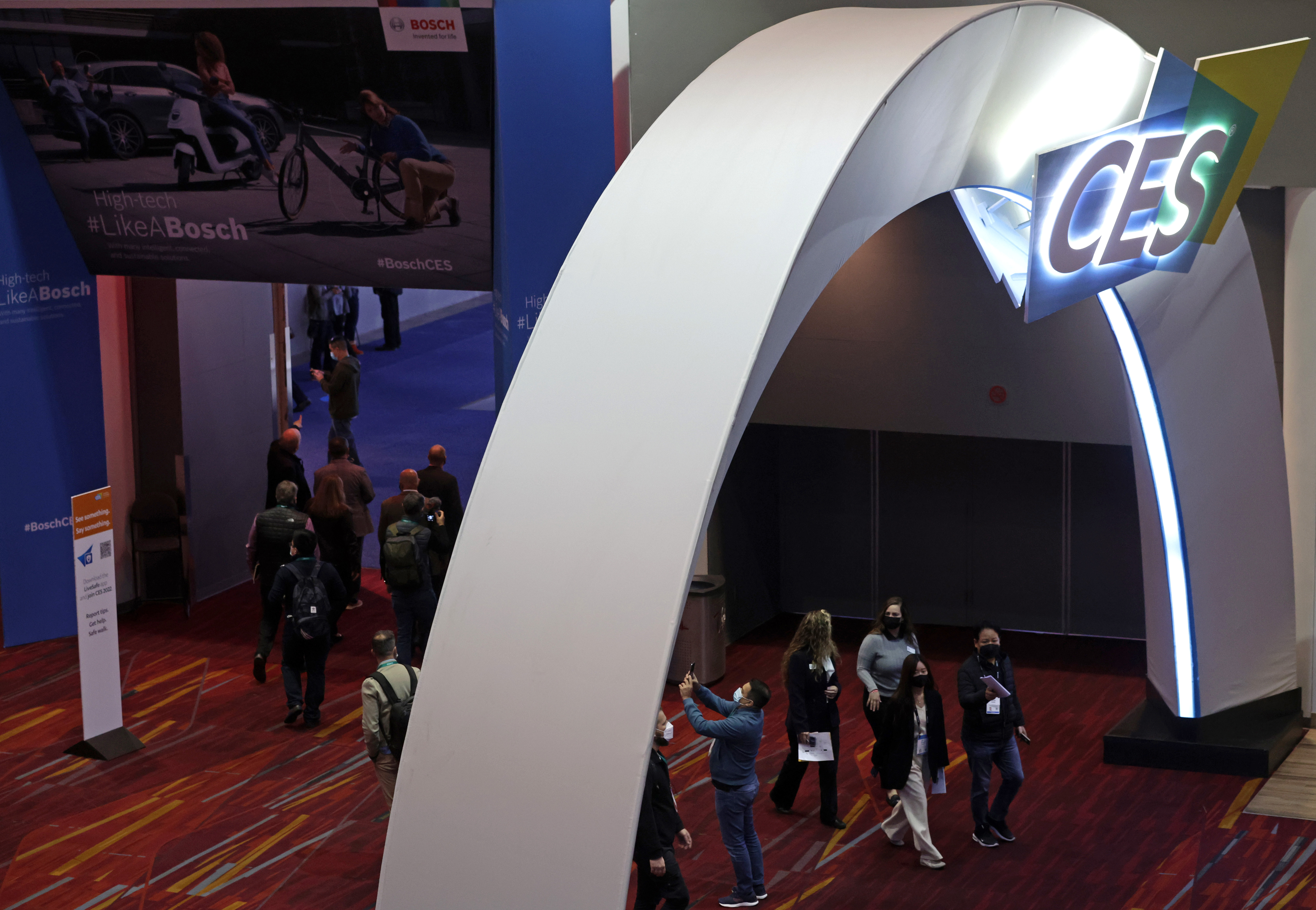 LAS VEGAS, NEVADA - JANUARY 05: Attendees pass through a hallway at the Las Vegas Convention Center on Day 1 of CES 2022, January 5, 2022 in Las Vegas, Nevada. CES, the world's largest annual consumer technology trade show, is being held in person through January 7, with some companies deciding to participate virtually only or canceling their attendance due to concerns over the major surge in COVID-19 cases. (Photo by Alex Wong/Getty Images)