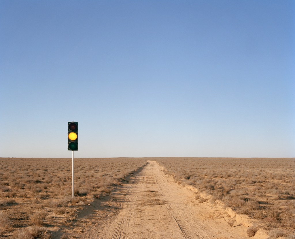 Yellow traffic light on desert road