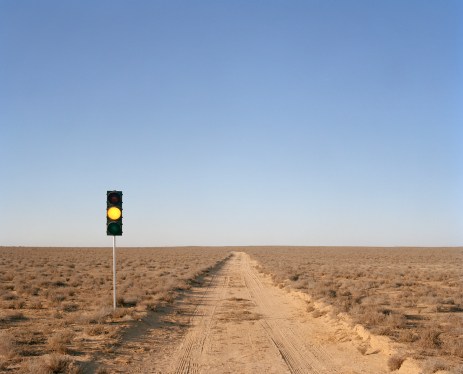 Yellow traffic light on desert road