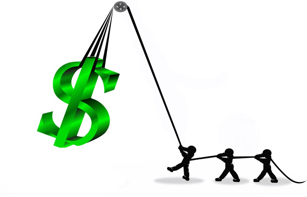 Small people hoisting a dollar sign on a pulley to symbolize raising funds.