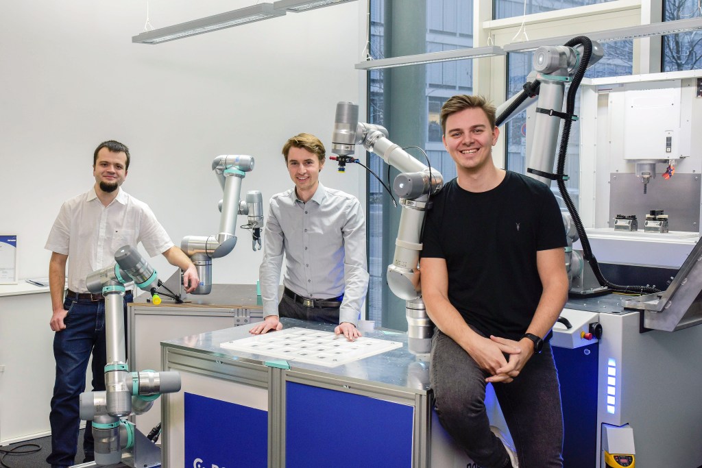 Robco team in lab with robotic devices