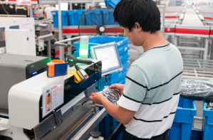 Man in factory standing at machine