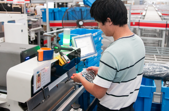 Man in factory standing at machine