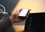 An image of the Ledger Stax crypto hardware wallet in a person's hand
