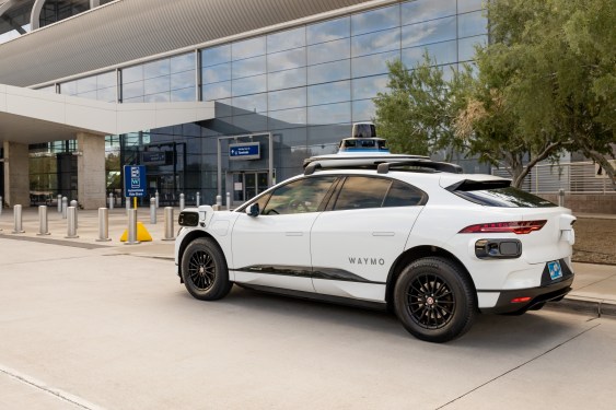 Jaguar I-pace, white SUV, at airport shuttle pickup