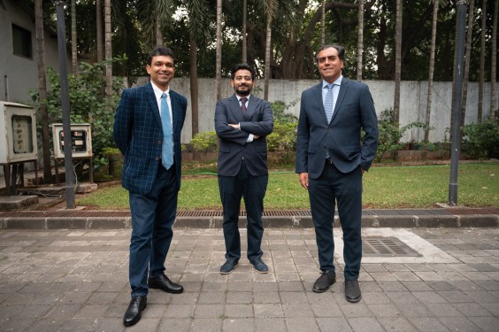 3 men standing outside
