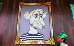 A customer waits in line at the grand opening of the Bored & Hungry pop-up burger restaurant, which uses NFT art for its branding, on April 9, 2022 in Long Beach, California. The restaurant is using images from the popular Bored Ape Yacht Club NFT (non-fungible token) art series with the owner stating that Bored & Hungry is the first food concept to utilize crypto art for branding.