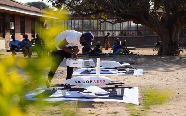 A man readies a Swoop Aero drone for delivery