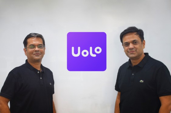 two men standing by Uolo sign