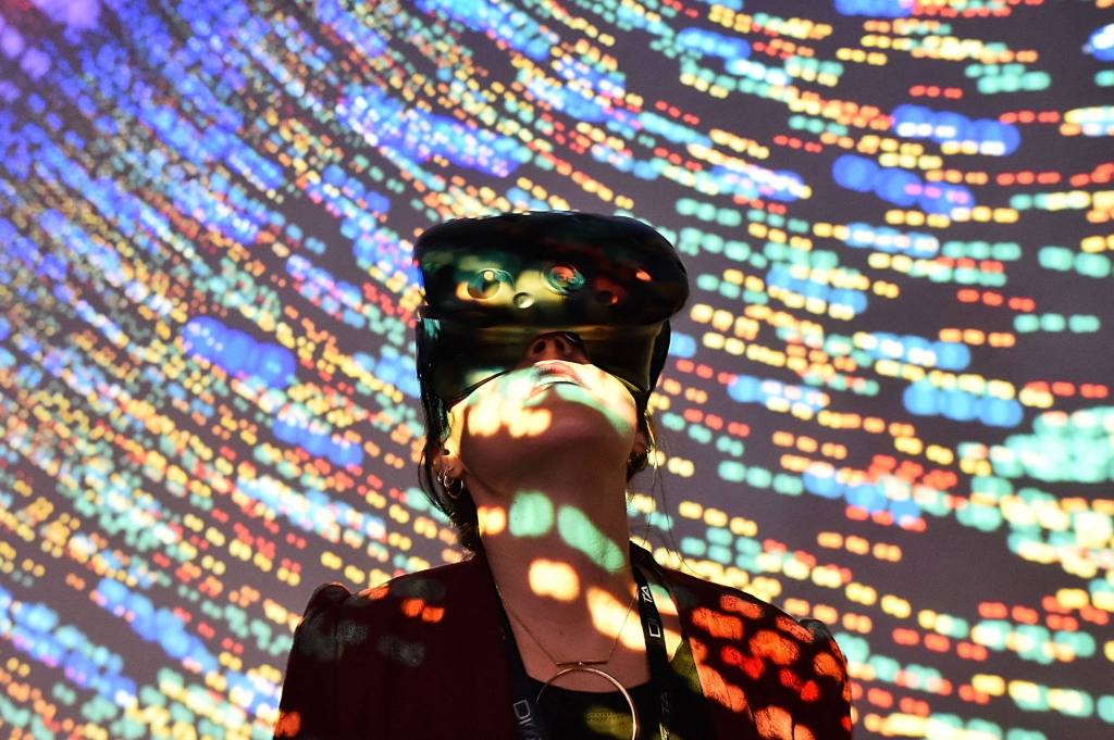 TOPSHOT - A visitor uses a Virtual Reality (VR) headset during the "Laval Virtual" virtual reality, augmented reality and 3D techonology show on April 6, 2018, in Laval, northwestern France. - The "Laval Virtual" virtual reality, augmented reality and 3D technology show runs from April 3 to April 8. (Photo by JEAN-FRANCOIS MONIER / AFP) (Photo by JEAN-FRANCOIS MONIER/AFP via Getty Images)