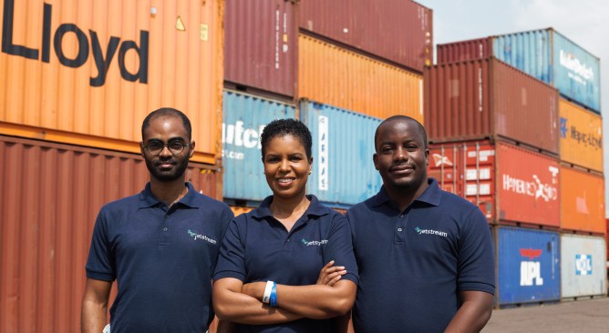 Jetstream Africa team standing in front of shipping containers.