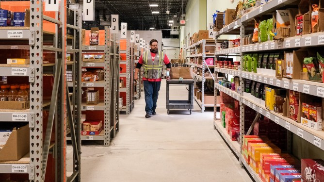 Man walking the aisles of Addie's drive-up grocery store Massachusetts