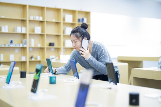 Young woman shopping for a smartphone.