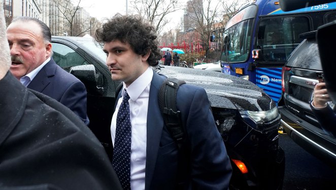 Former FTX chief executive Sam Bankman-Fried (C) arrives to enter a plea before US District Judge Lewis Kaplan in the Manhattan federal court, New York, January 3, 2023. - Bankman-Fried faces criminal fraud charges over the spectacular collapse of his crypto exchange. (Photo by TIMOTHY A. CLARY/AFP via Getty Images)