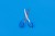 Small blue scissors on a blue background