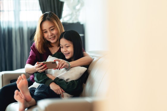 Mother and daughter looking at a smartphone together, used in a post about Supermom