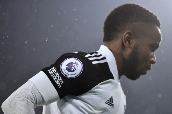 A no room for racism logo and premier league logo is seen on the shirt of Ademola Lookman of Fulham during the Premier League match between Fulham and West Ham United at Craven Cottage on February 06, 2021 in London, England. Sporting stadiums around the UK remain under strict restrictions due to the Coronavirus Pandemic as Government social distancing laws prohibit fans inside venues resulting in games being played behind closed doors.
