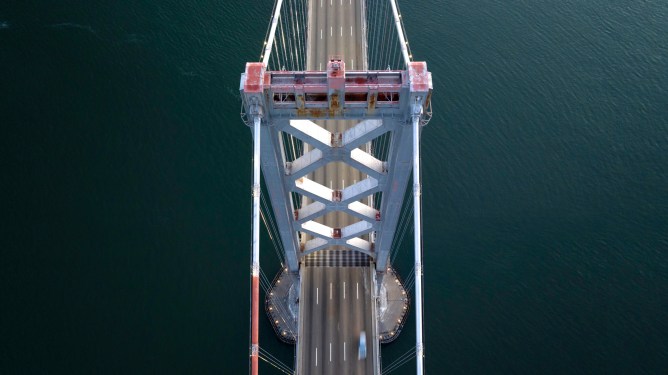 aerial photo looking down at early morning traffic on the San Francisco Bay Bridge.