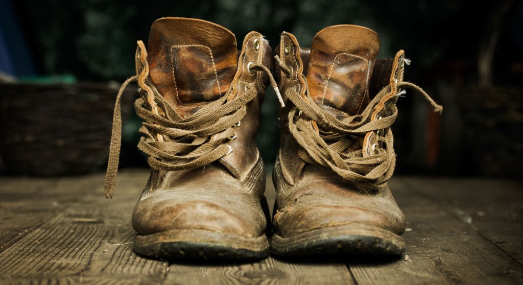 Pair of old worn leather boots on wooden floor boards (Image credits: lucielang/Getty Images)