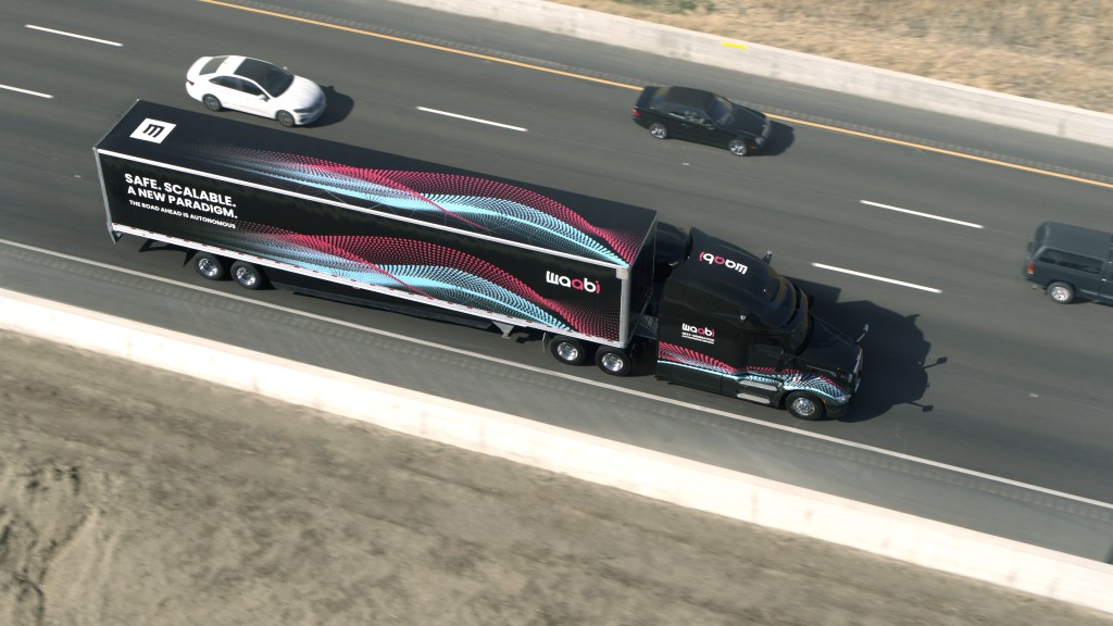 Aerial photo of semi-truck by Waabi with words "Safe. Scalable. A new paradigm. The road ahead is autonomous."